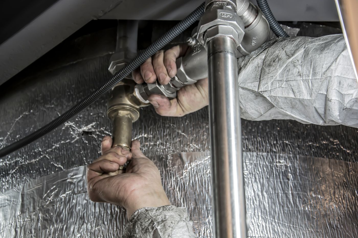 Professional installer connecting water treatment plumbing