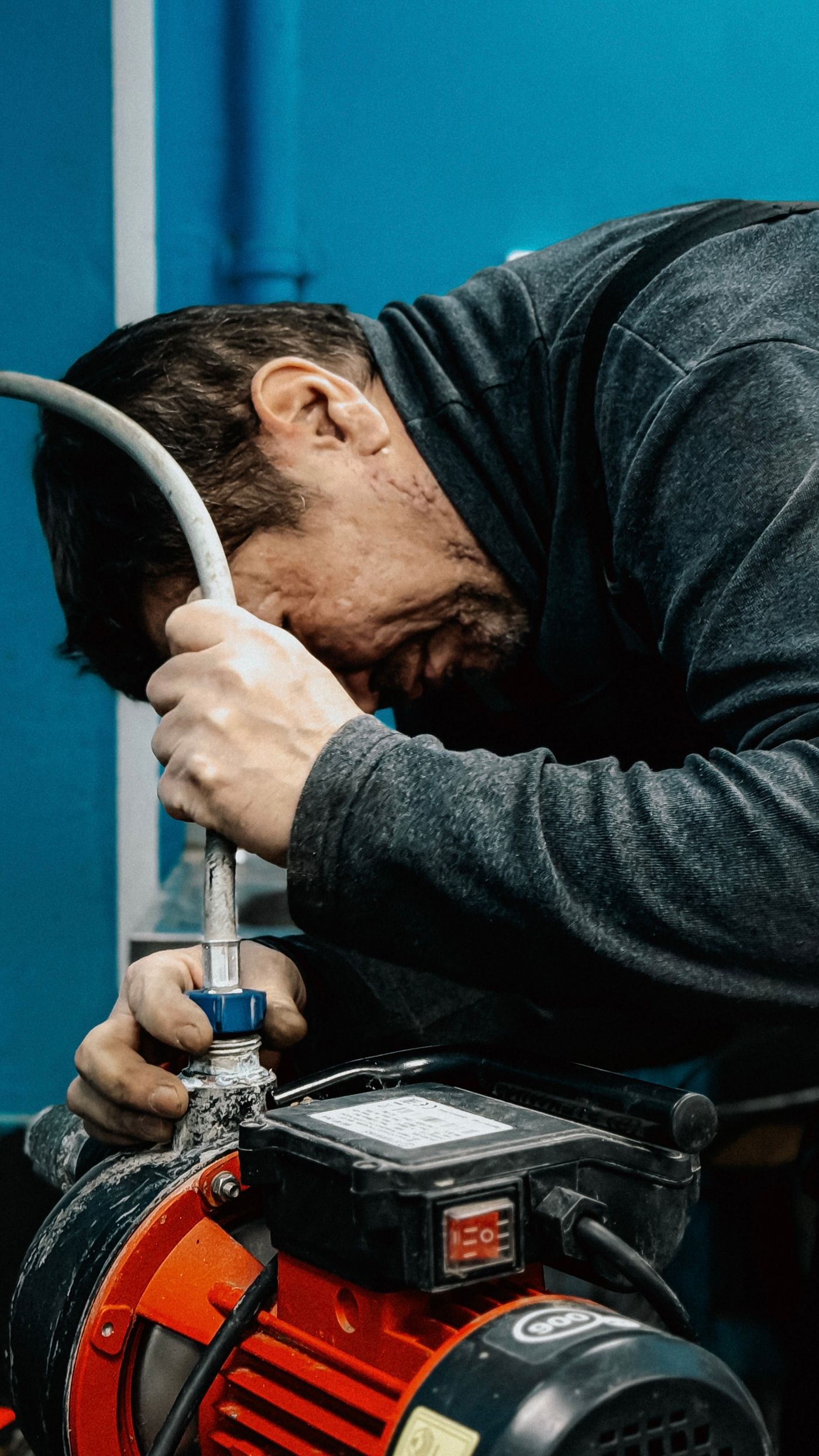 Technician servicing a residential well water pump system